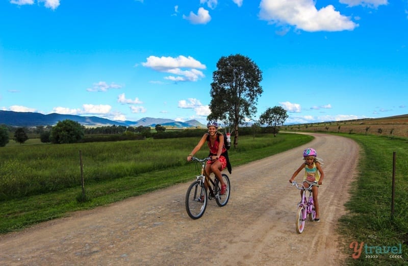 woman and child cycling down country road