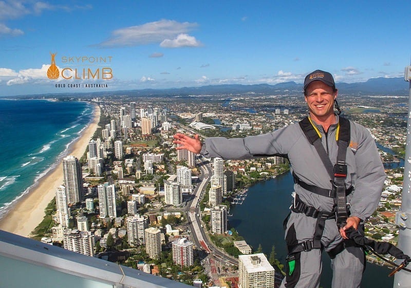 man standing on a skyline wearing a harness