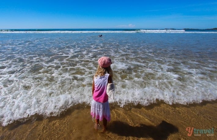 A little girl standing in the ocean