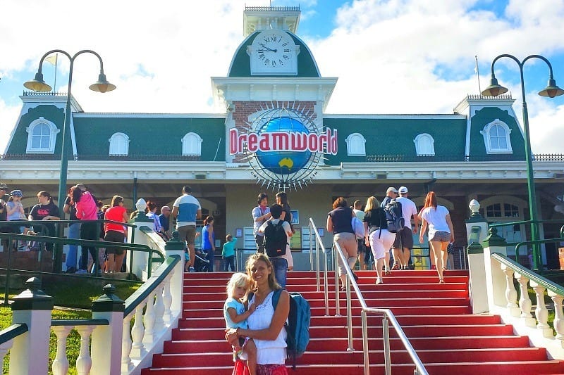 mum and child standing on the stairs at the entrance to Dreamworld, Gold Coast, Australia