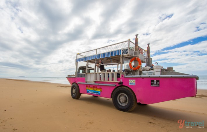 pink truck on the beach