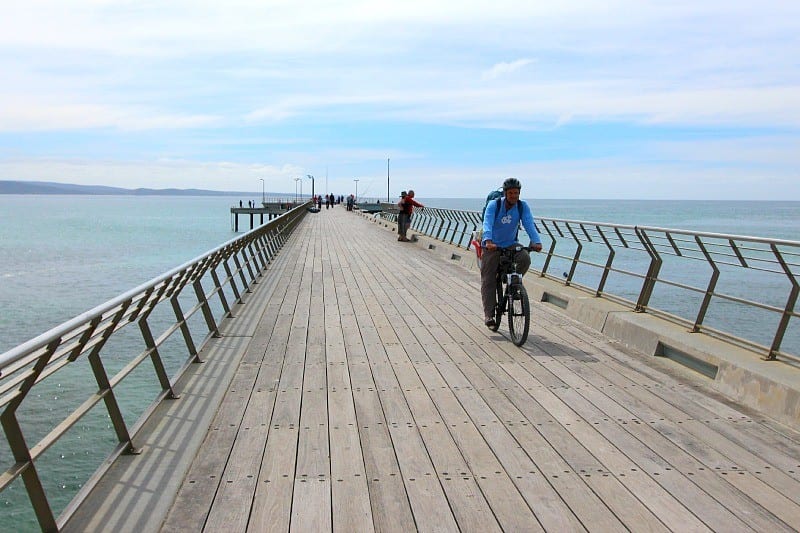 man riding bike on pier
