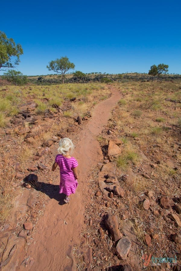 child walking down a dirt trail