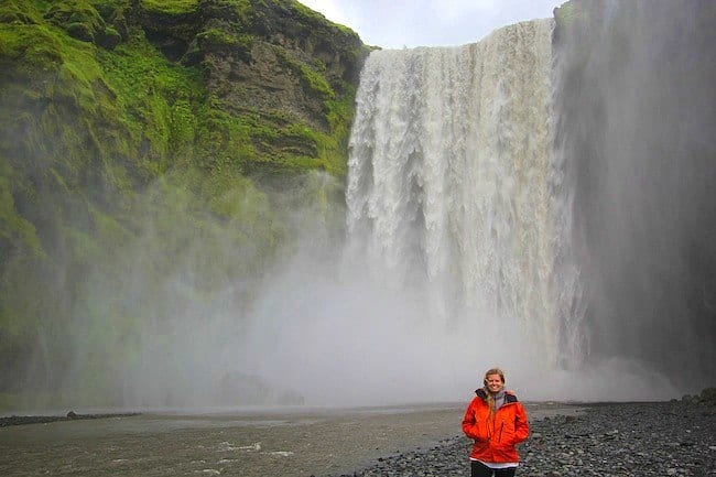 person standing in front of a waterfall