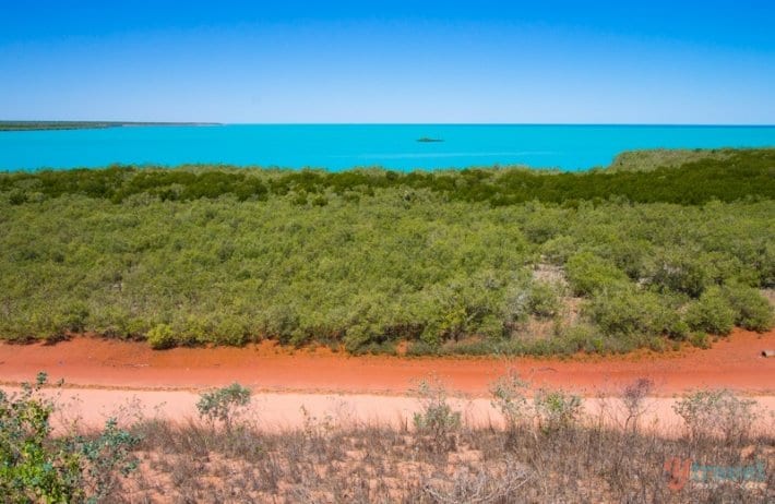 orange dirt, green bush and turquoise water of Broome as seen from Mangrove Hotel -