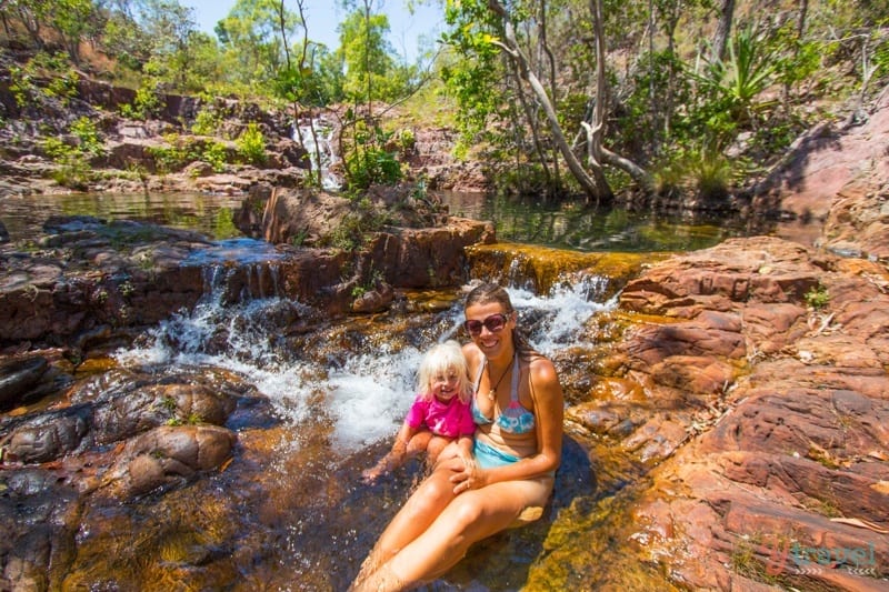 Caz and the tirls sitting on a rock beside pool of water Litchfield National Park