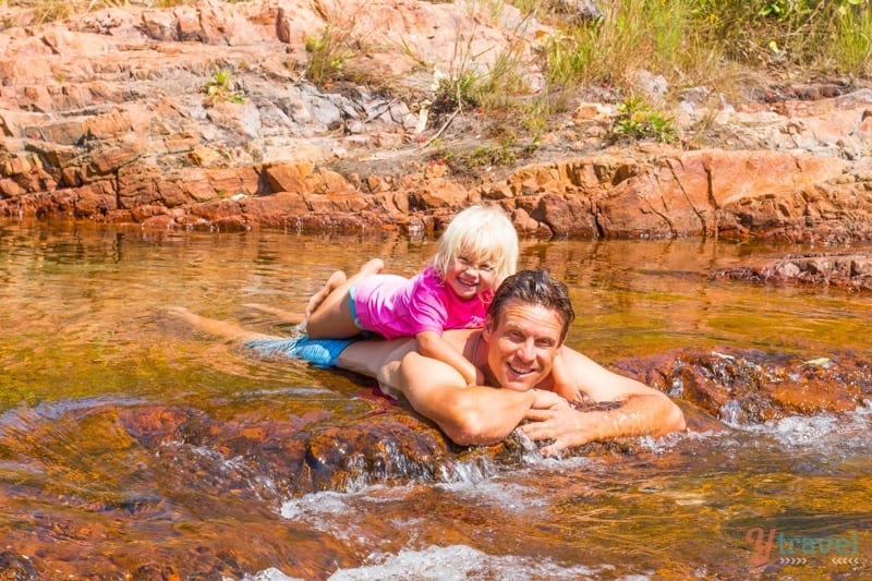savannah on craig's back lying in the water Litchfield National Park, Northern 
