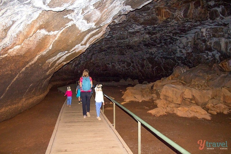 people walking into a cave