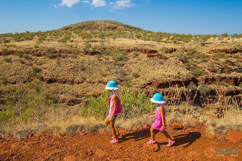 children walking on a dirt path 