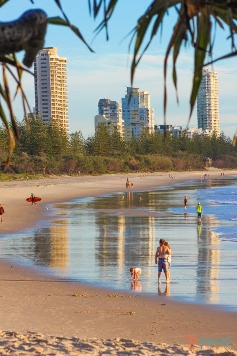 view of ocean with burleigh skyscrapers in background and reflected in water