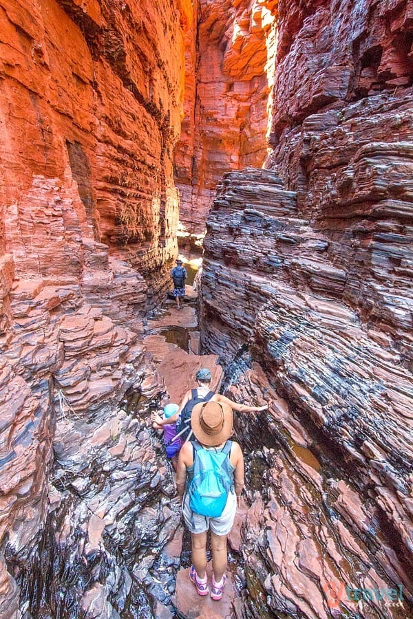 people walking through a canyon