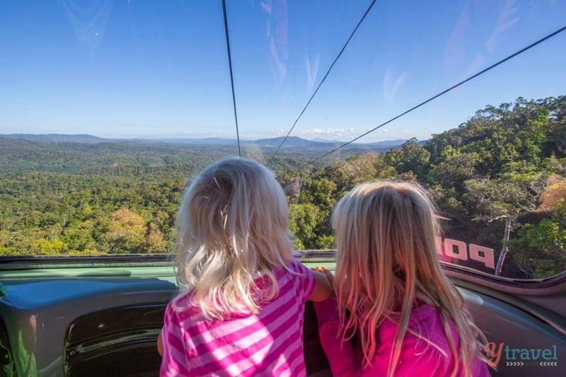 girls looking out the window at the rainforest on the Skyrail Rainforest Cableway - Cairns, Australia