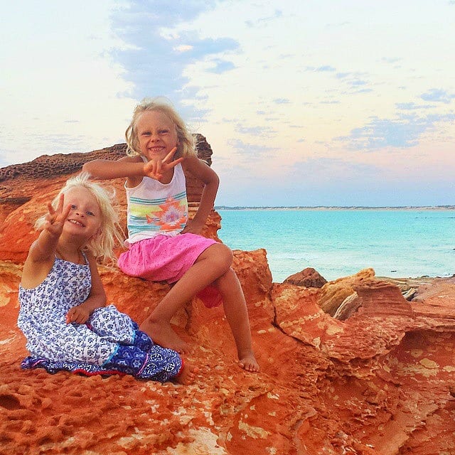 girls sitting on a rock 