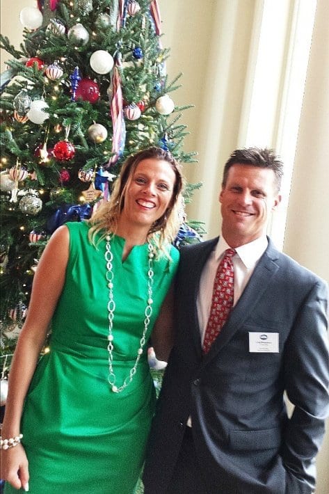 couple posing in front of Christmas tree in the White House