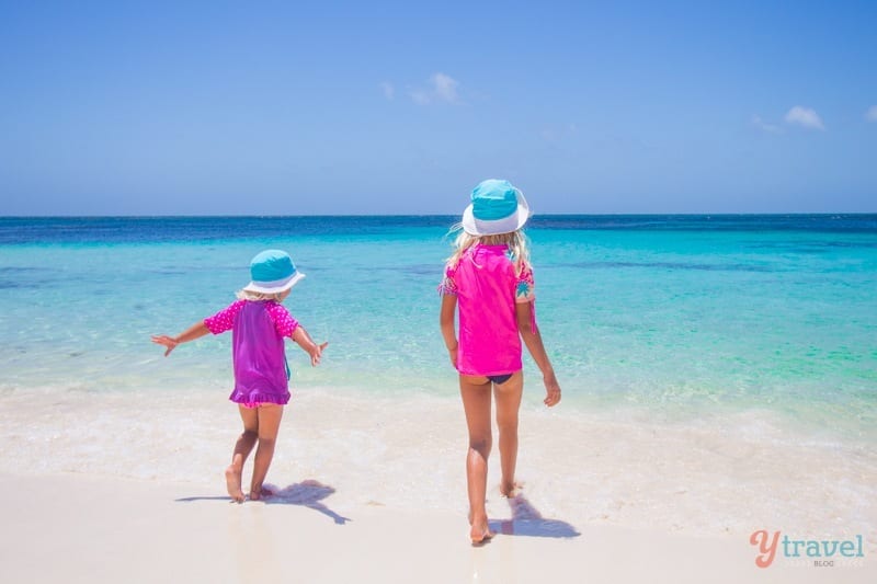 little girls walking into the ocean