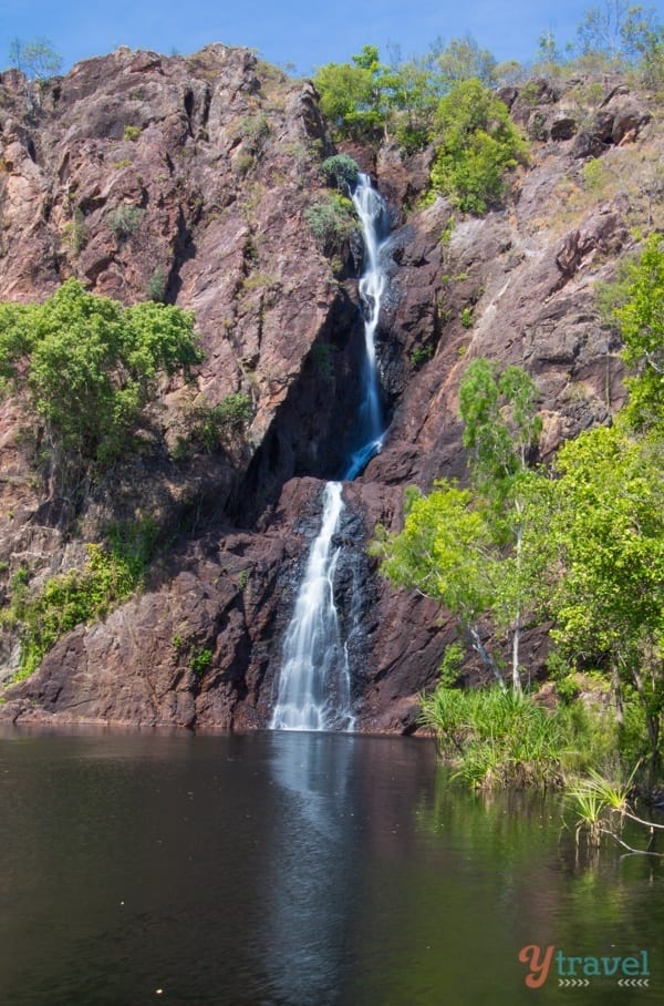 A large waterfall over a body of water