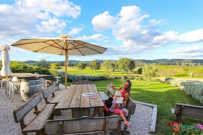 lady and child sitting at picnic table with wine