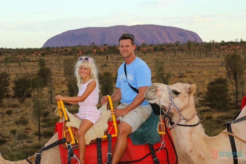 people sitting on camels