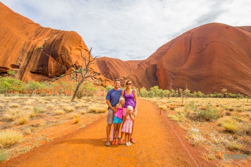family standing on a dirt path
