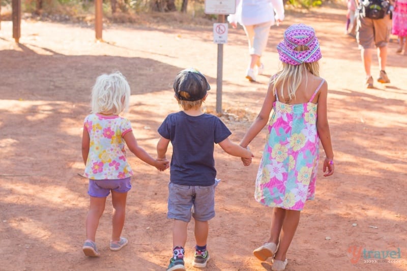 children holding hands walking on ubirr tour