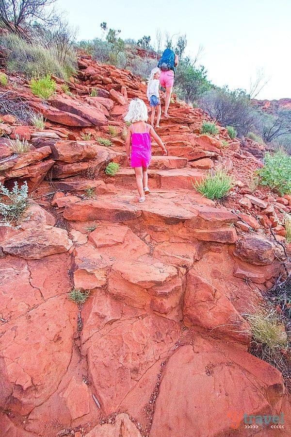 people walking up a rock trail