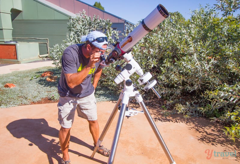 man looking through a telescope