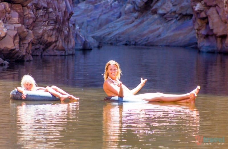 caroline and kalyra sitting on tubes in a river