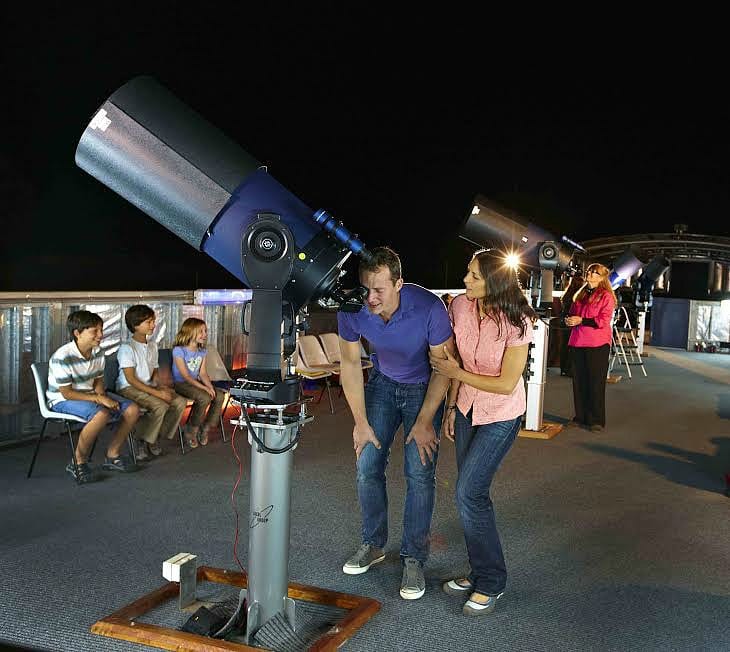 people looking through a telescope
