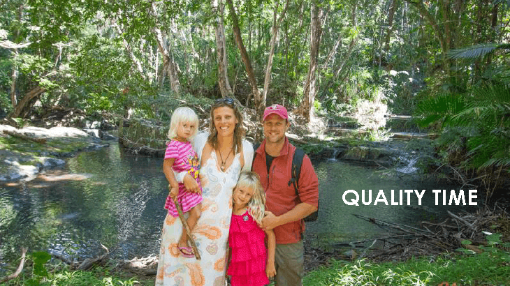 family posing in rainforest