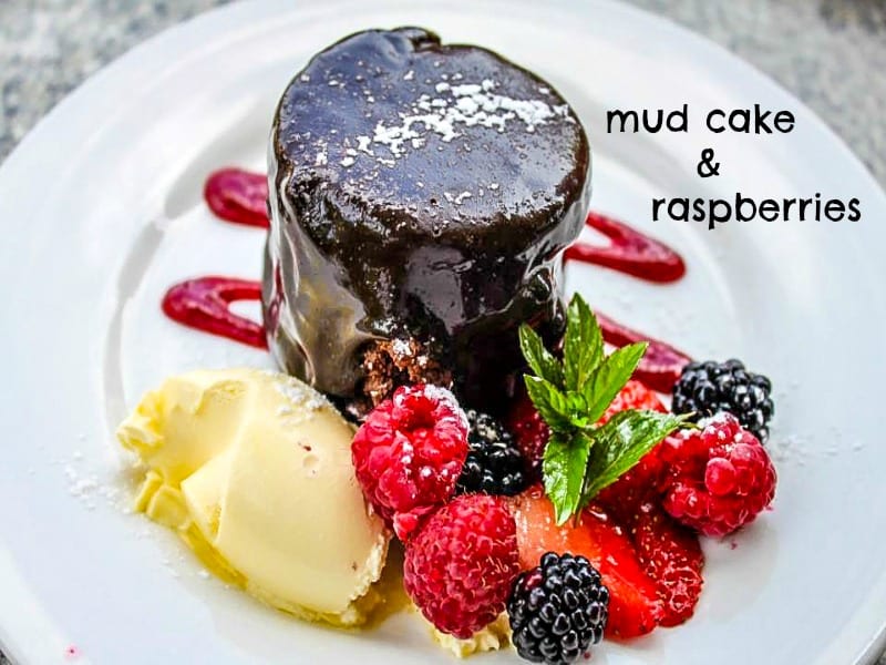 mudcake, cream and raspberries on the plate