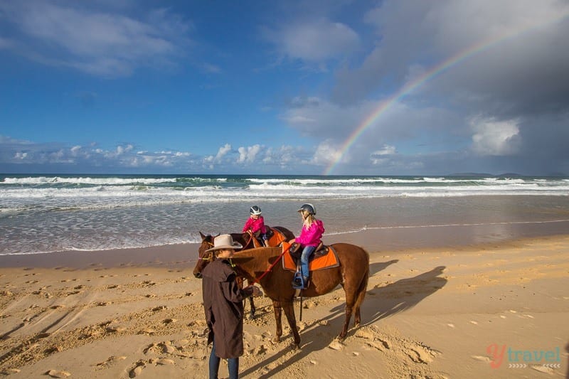 people beach horseback riding