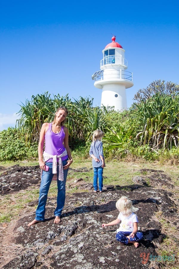 people standing in front of a lighthouse
