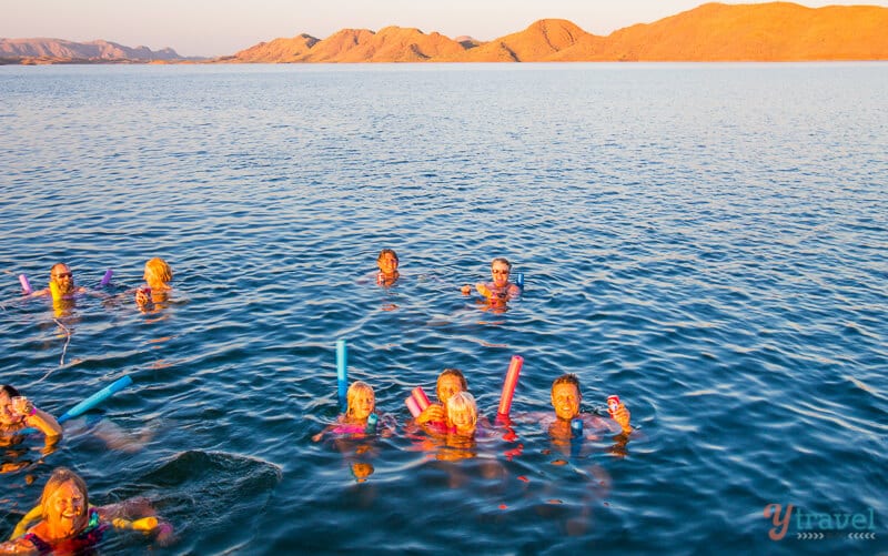 peopel swimming with floaties in Lake Argyle