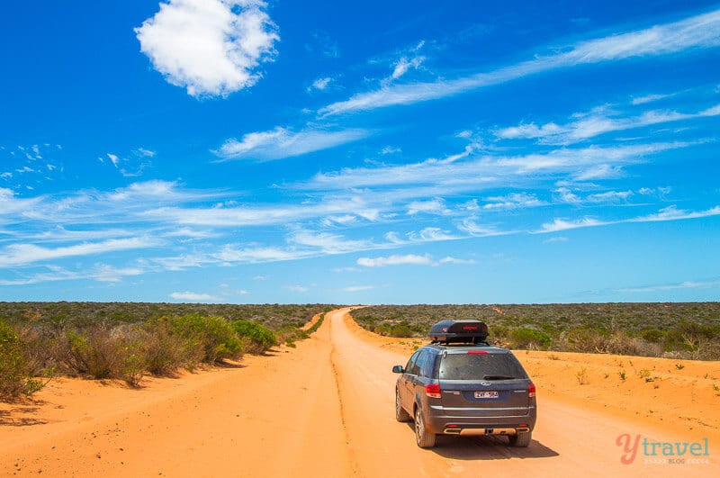 car driving down red dirt track in Francois Peron National Park