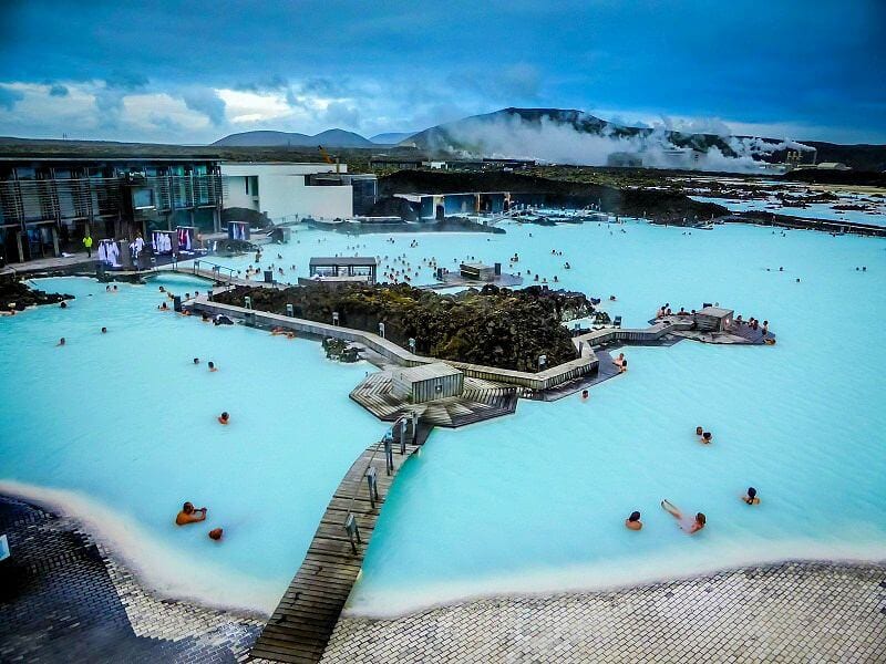 people swimming in The Blue Lagoon - Iceland