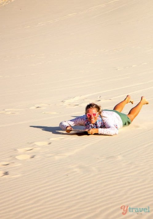 woman Sand Tobogganing on Moreton Island, Queensland, Australia