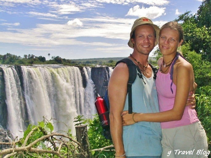 couple standing in front of a waterfall
