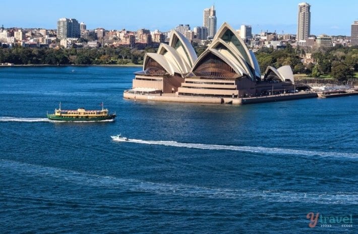 ferry cruising past sydney opera house