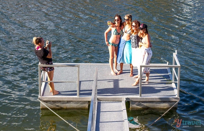 people standing on a lake dock