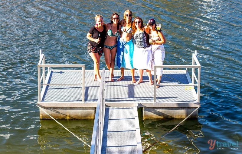 people standing on a lake dock
