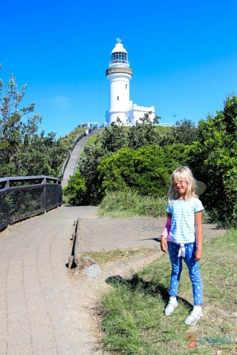 young girl posing in front of Byron Bay Lighthouse, Australia