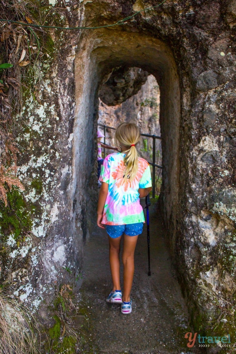girl walking through a cave
