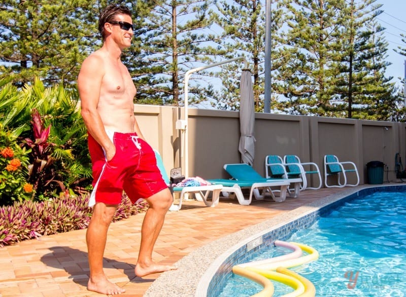 man standing beside a pool