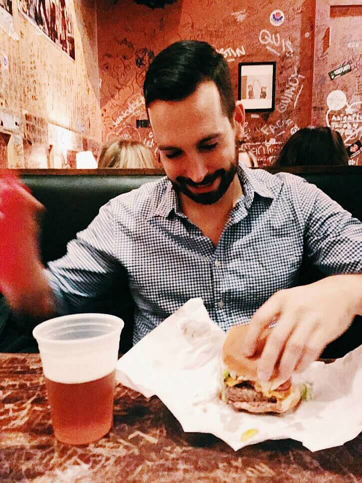man smiling at Cheeseburgers (and beer) at Burger Joint 