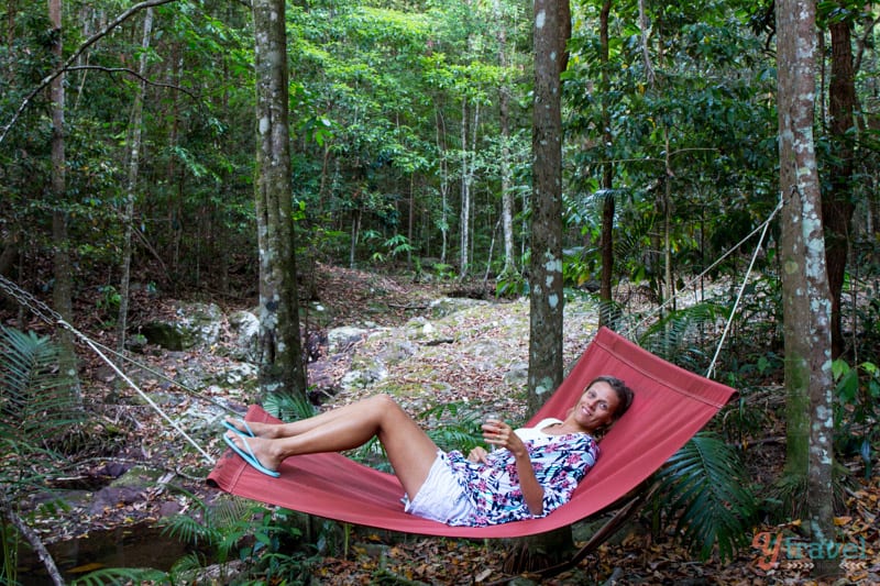 woman lying on a hammock in a forest