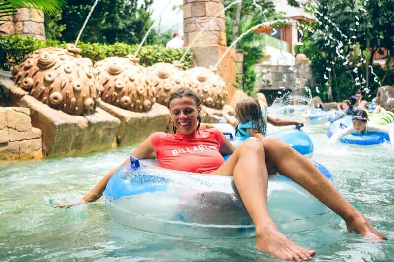 woman floating connected  conduit  down   lazy river