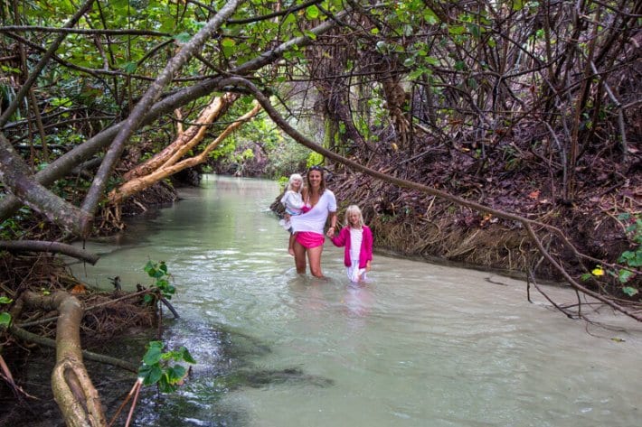 woman and two girls wading through Eli Creek -