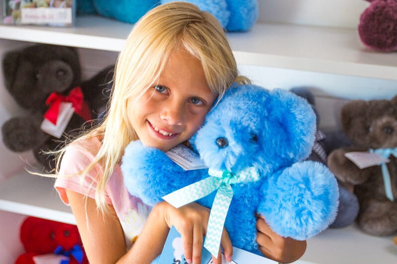 A little girl holding a stuffed animal