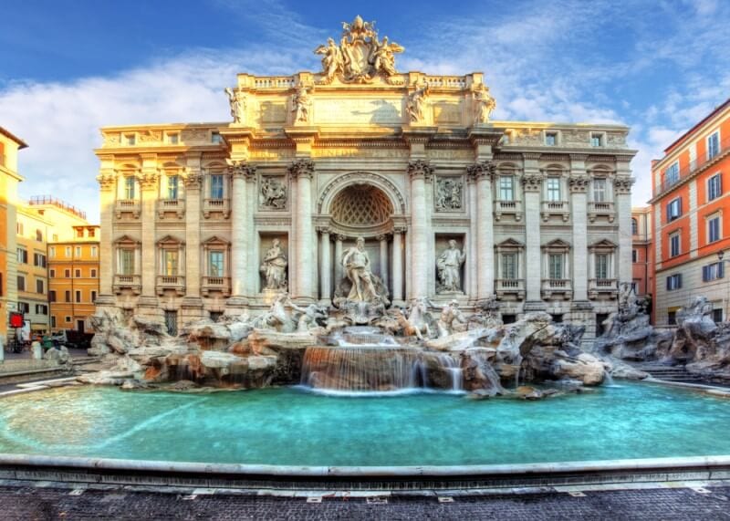 A large building with a trevi fountain in the front