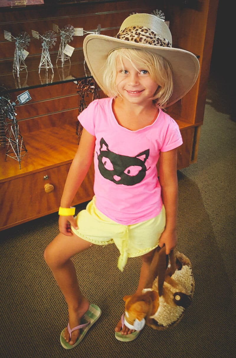 young girl with cowgirl hat on